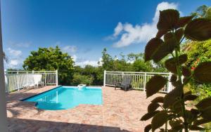 a swimming pool in the backyard of a house at Gîte L'adérobade in Le Gosier