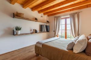 a bedroom with a bed and a window at Casa Anna in Trichiana
