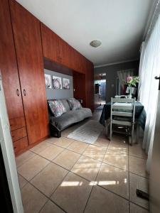 a living room with a couch and a table at ChezBelle, self-catering 2 sleeper in Constantia with self check-in in Cape Town