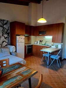 a kitchen with a table and a kitchen with a dining room at Pirin Golf hotel, Apartment Chalet style in Razlog