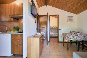 a kitchen and a dining room with a table at Caravelle Camping Village in Ceriale