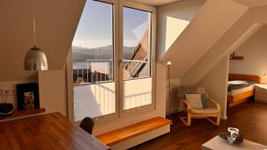 a room with a large window and a bedroom at Feriendomizil Ösetalblick in Bad Driburg