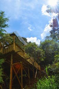 a tree house with a deck on a hill at Cabaña Madre Selva in San Vicente +28 photos