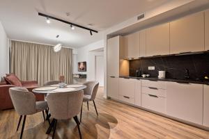 a kitchen and a living room with a table and chairs at Mountain Bliss in Sinaia