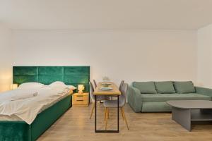 a bedroom with a bed and a couch at Mountain Bliss in Sinaia