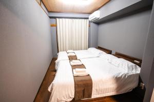 Postel nebo postele na pokoji v ubytování Mitomi inn