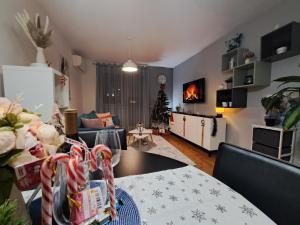 a living room with a christmas tree and a table at Apartment CityAna - private garage, 0-24 Self Check In in Zagreb