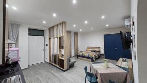 a hotel room with a bed and a table and chairs at Etruria Apartments Salerno in Salerno