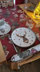 a table with a plate with a deer on it at Appartamento Gentiana psdCIR0037 in Pré-Saint-Didier