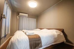 Postel nebo postele na pokoji v ubytování Mitomi inn