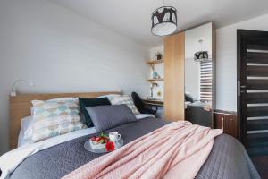 Posteľ alebo postele v izbe v ubytovaní P&O Apartments Wola Tarasy