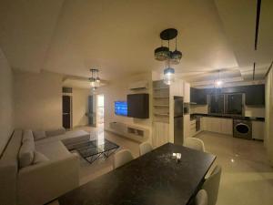a living room with a couch and a dining table at Tabarja hills in ‘Ayn aş Şughayrah