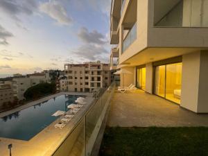 a balcony of a building with a swimming pool at Tabarja hills in ‘Ayn aş Şughayrah