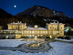 a large building in the snow at night at Appartamento Gentiana psdCIR0037 in Pré-Saint-Didier +19 photos