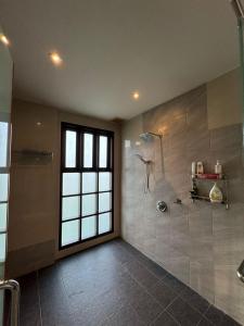 a large bathroom with a shower and a window at Laman Padi Villa in langkawi in Ulu Melaka +7 photos