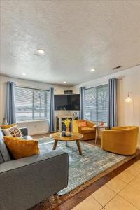a living room with a couch and a table at Private Hot Tub Sauna Prime Location in Garden City