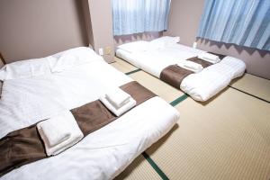 Postel nebo postele na pokoji v ubytování Mitomi inn