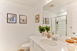 a white bathroom with a sink and a toilet at Right off i15 Rooftop Patio BBQ Grill in American Fork +48 photos