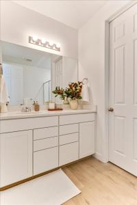 a white bathroom with a sink and a mirror at Right off i15 Rooftop Patio BBQ Grill in American Fork
