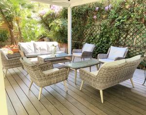 a patio with chairs and a table and an umbrella at Hotel Fenix in Rome