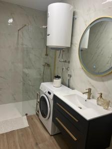 a bathroom with a washing machine and a sink at Maja in Posušje +13 photos