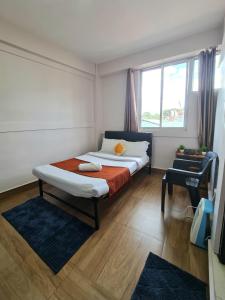 a bedroom with a bed and a window at B FINE Guest House in Shillong