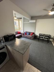 a living room with a couch and a table at Georges 2 Bedroom Apartment in Limassol +14 photos