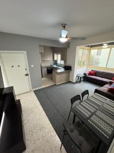 a living room with a couch and a table at Georges 2 Bedroom Apartment in Limassol
