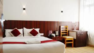 Postel nebo postele na pokoji v ubytování Hotel Sandalwood