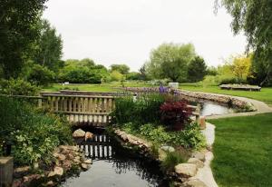 a garden with a bridge and a pond at Private Room & Bathroom Hiking Trails Close By in Ogden