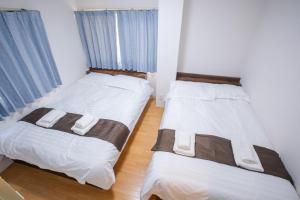 Postel nebo postele na pokoji v ubytování Mitomi inn