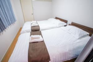 Postel nebo postele na pokoji v ubytování Mitomi inn