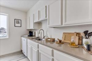 a kitchen with white cabinets and a sink at 5 Mins off i15 Pickle Ball Courts Close By in Bountiful