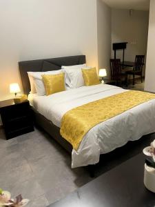 a bedroom with a large bed with yellow and white pillows at Ista Vacation Homes Rental LLC in Dubai