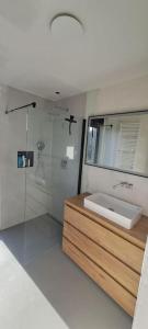 a white bathroom with a sink and a shower at Modern spatious house near Bruges in Bruges