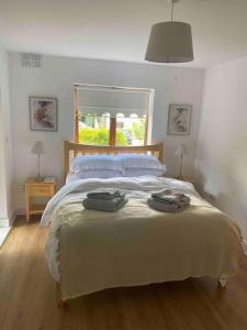 a bedroom with a bed with two towels on it at BTown 2 Bed 2 Bath in Ballybrack