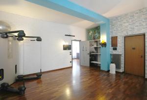 a room with a gym with a hard wood floor and a room with a door at Mywellness Apartment in Foggia
