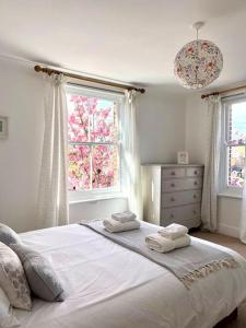 a bedroom with a large bed with two towels on it at New Forest Cottage in Lyndhurst