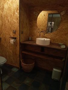 a bathroom with a sink and a mirror at Comme à la maison in Tiffauges
