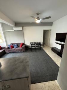 a living room with a couch and a table at Georges 2 Bedroom Apartment in Limassol