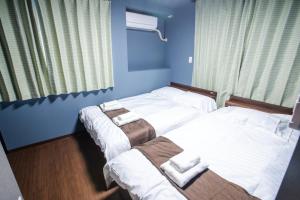 Postel nebo postele na pokoji v ubytování Mitomi inn