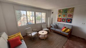 a living room with a couch and a table at Casa Frijol 20metres from the beach in Los Alcázares