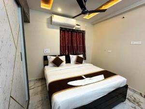 a bedroom with two beds and a window at Urban Nest Homestay in Tirupati