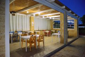 a patio with a table and chairs on a deck at B&B Domus Terra Mare in Torre San Giovanni Ugento
