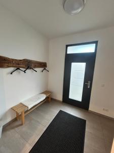 a room with a door and a bench in front of it at Chill-out in Heilbad Heiligenstadt