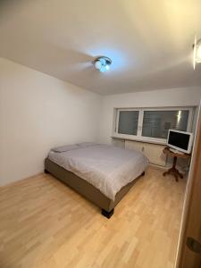 a bedroom with a bed and a desk with a computer at Vista Rosengarten in Bolzano