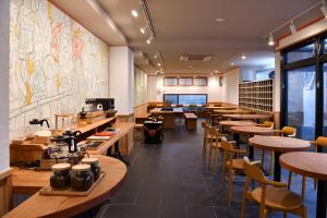 a dining room with wooden tables and chairs at Wanosato Kyoto Musee in Kyoto