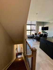 a staircase leading to a living room and dining room at Charles Peak Condo - JC Heights in Jersey City +14 photos