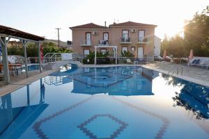 a large swimming pool in front of a house at Paradise Studios in Petra