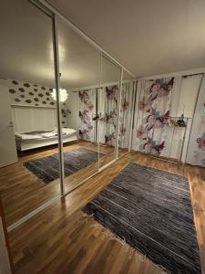 a room with mirrors and rugs on the walls at Lapland Second Home in Rovaniemi